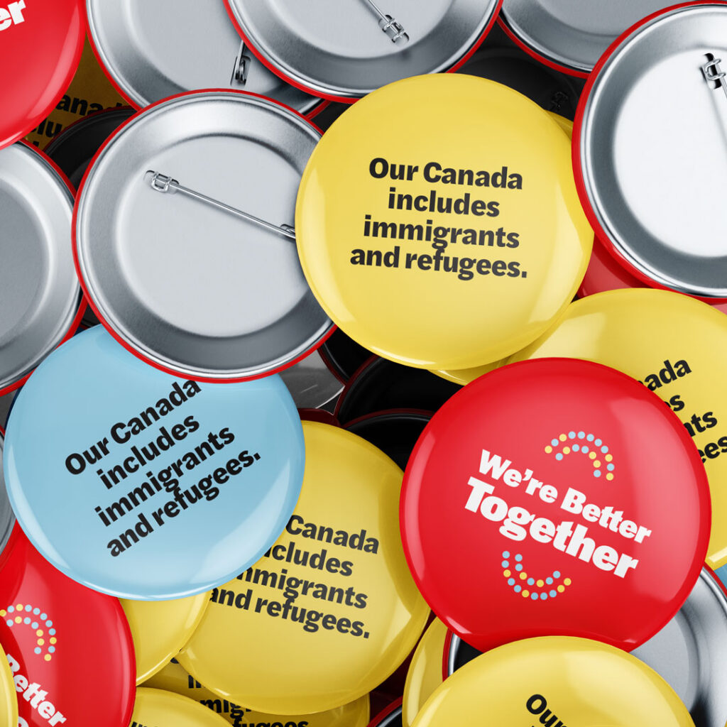 A selection of multicoloured button pins reading "Better Together" and "Our Canada includes immigrants and refugees."